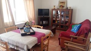 a living room with a table and a chair at La Casa De La Puebla in La Puebla de Montalbán