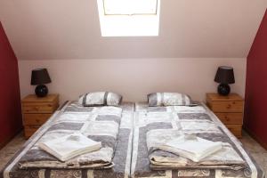 a bedroom with a bed with two night stands and a window at Tammeveski Holiday House in Kobruvere