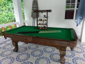 a green pool table in a room with at Polish Princess Guest House in Port Antonio