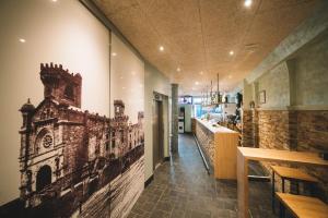 a restaurant with a mural of a building on the wall at Hotel Castillo de Javier in Pamplona