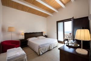 En eller flere senger på et rom på La Dimora di Spartivento - BW Signature Collection