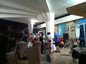 a group of people standing in a room with tables at Hotel Eden in San Domino
