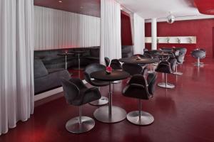 a room with two chairs and a table with chairs at Hotel Q! Berlin in Berlin