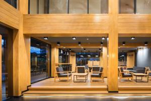 a lobby with chairs and tables in a building at Asana Hotel & Residence in Pattaya Central