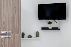 a living room with a television on a wall at Casa Vacanza Paradiso in Maiori