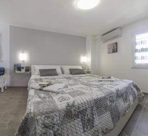 a bedroom with a large bed with a quilt on it at Casa Vacanza Paradiso in Maiori
