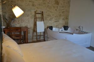 a bedroom with a bed and a sink and a table at Agriturismo Fontefredda in Tavenna