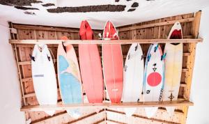 a bunch of surfboards are lined up on a rack at Casa da Lagoa AL 416 in Fajã da Caldeira de Santo Cristo