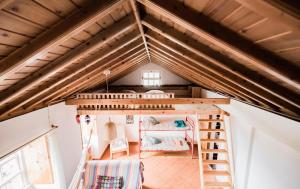 a loft bed in a tiny house at Casa da Lagoa AL 416 in Fajã da Caldeira de Santo Cristo