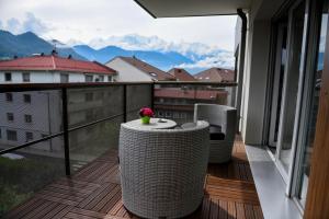 a balcony with a table and a view of mountains at Appartement au pied du Mont-Blanc ! in Sallanches