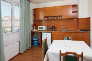 a kitchen with a table with a white table cloth at Hotel Sunrise in Ravda
