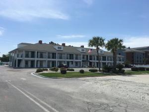 a large white building with palm trees and a street at Jameson Inn Douglas in Douglas