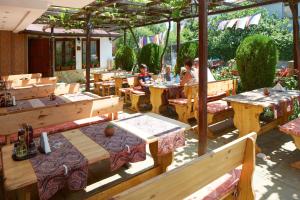 a restaurant with tables and people sitting at tables at Hotel Sunrise in Ravda