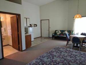 a room with a bed and a table and a couch at Rock Creek Mercantile & Motel in Clinton