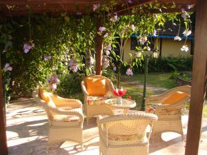 a group of wicker chairs and a table in a yard at Repousada Sana in Sana