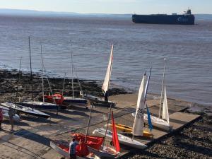 a group of sailboats lined up on the shore at The Nook @ Drop Anchor in Portishead