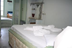A bed or beds in a room at Studios Naxos