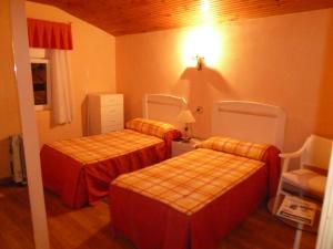 A bed or beds in a room at Hostal de la Playa