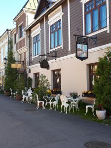 a group of tables and chairs in front of a building at Hotel Villa Antonius in Naantali