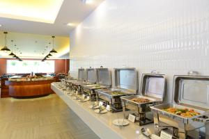 a buffet line of food in a restaurant at Hisea Huahin Hotel in Hua Hin