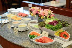 a table topped with bowls of different types of food at Hisea Huahin Hotel in Hua Hin