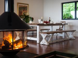 a fireplace in a living room with a table at Balmoral 575 in Montville