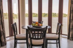 a table with a bowl of fruit in front of a window at Prestige Hotel in Belene