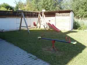 a playground in a yard with a swing at Vila Jaro in Chocerady