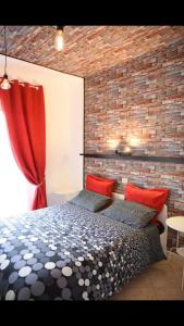 a bedroom with a bed and a brick wall at la casa di asmei b & b Lucera in Lucera