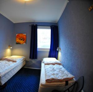 a bedroom with two beds and a window at Gulen Dive Resort in Dalsøyra