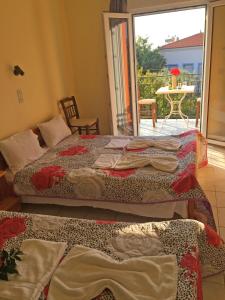 two beds sitting in a room with a balcony at Acapoulco apartments in Anaxos