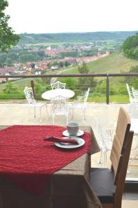 a table with a napkin and a cup on top at Kirschberghof Gästehaus und Weinverkauf in Sommerhausen