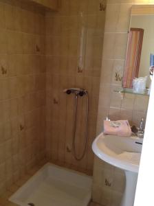 a bathroom with a shower and a sink at Hôtel de la plage in Agay - Saint Raphael