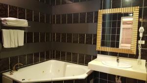 a bathroom with a tub and a sink at Wind Coast Motel in Hsinchu City