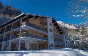 a large building in the snow in the mountains at Les Cimes du Montblanc in Les Houches
