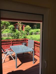 a glass table and two chairs on a deck at Kiel Leuchtturm in Kiel