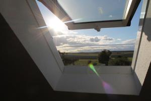 a view from the inside of a building with a window at Gästehaus Hubertushof - 24h Check-In in Hausen