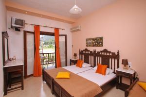 a bedroom with a large bed and a balcony at Maria Studios in Neo Klima