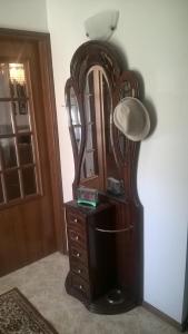 a wooden dresser with a large mirror next to a door at Casa de Campo São Bernardo in Penalva do Castelo