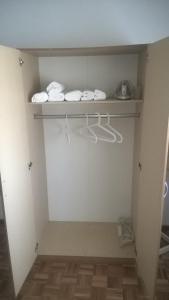 a room with a closet with white doors and towels at Casa de Campo São Bernardo in Penalva do Castelo