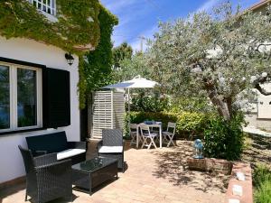 a patio with a table and chairs and an umbrella at Villa Rosaria in Vasto