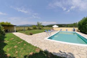 a swimming pool in a yard with chairs at Corfu Villa Ermioli with Pool in Giannádes
