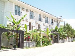 a white building with plants in front of it at Hotel Vanilla in Fethiye