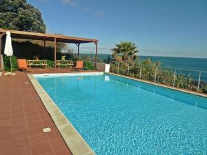 a swimming pool with a view of the ocean at QVA - Quinta Velha das Amoreiras in Vila Franca do Campo