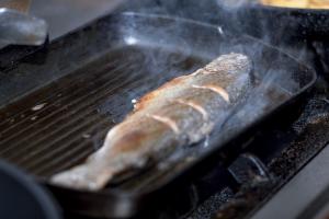 kawałek mięsa gotuje się na grillu w obiekcie Hotel Semitronix w mieście Peć