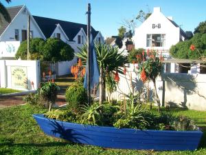 
a blue boat sitting on top of a green field at Sandriver Lodge in St Francis Bay
