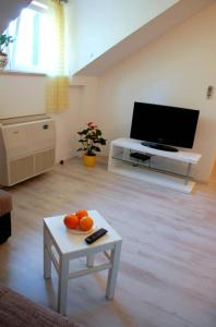 a living room with a table with oranges on it at Villa Violić in Zaton