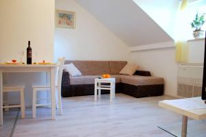 a living room with a couch and a table at Villa Violić in Zaton