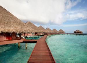 a row of overwater bungalows in the water at Adaaran Club Rannalhi - All Inclusive - 45 Minutes away from Male by Speedboat in South Male Atoll