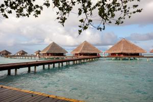 a row of overwater bungalows in the water at Adaaran Club Rannalhi - All Inclusive - 45 Minutes away from Male by Speedboat in South Male Atoll